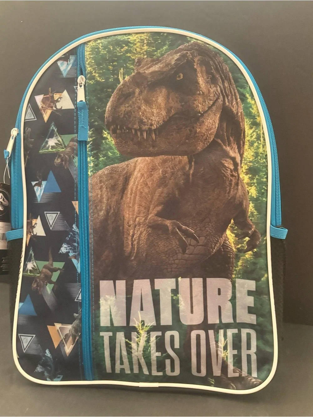 Kids Dinosaur Backpack in Blue and black with 'Nature Takes Over' Graphic